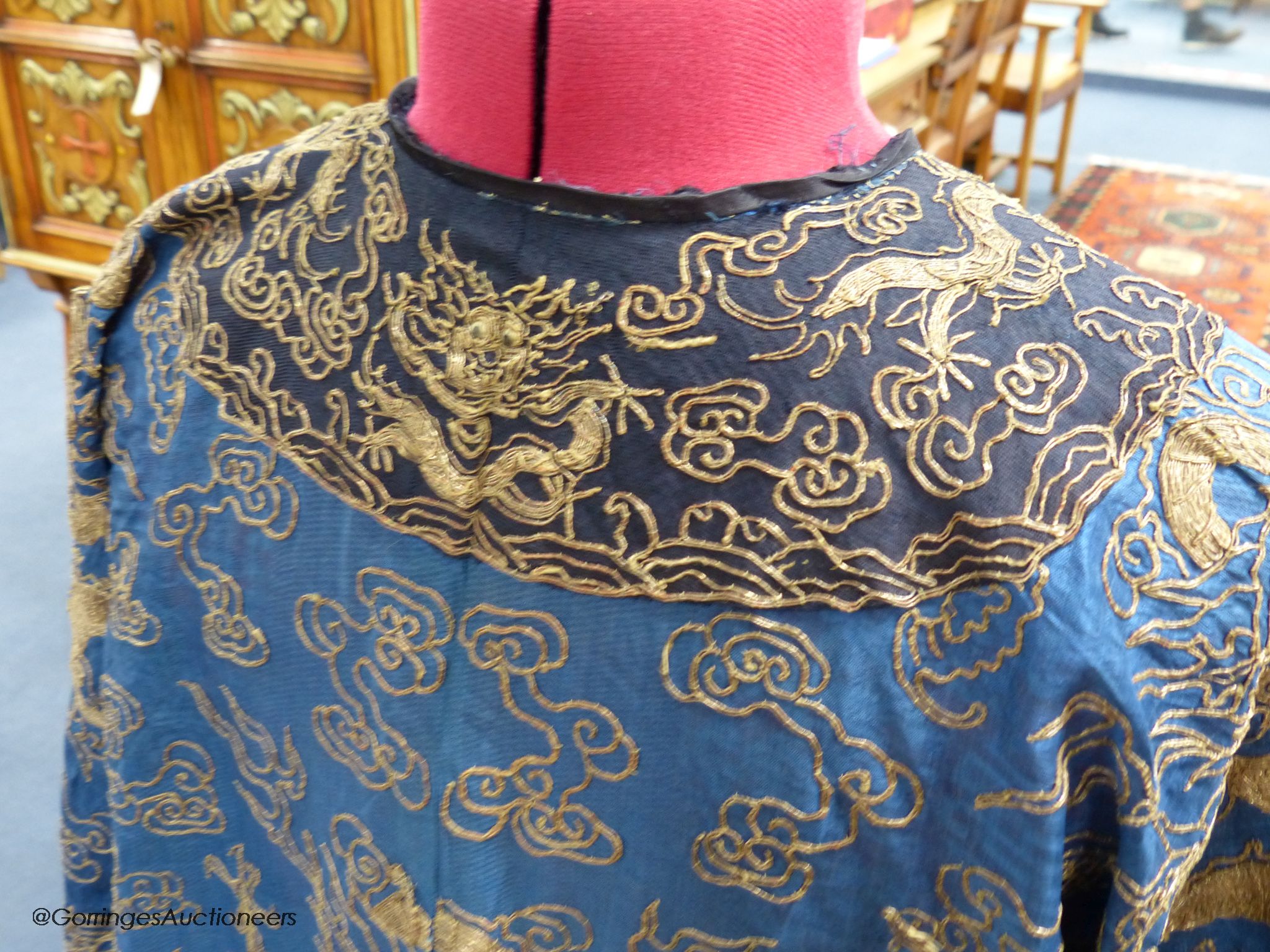 An early 20th century Chinese Summer robe, worked on fine gauze, with gold thread dragon embroidery